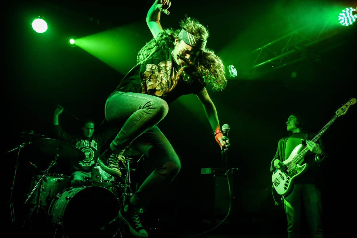 person performing on stage jumping in air