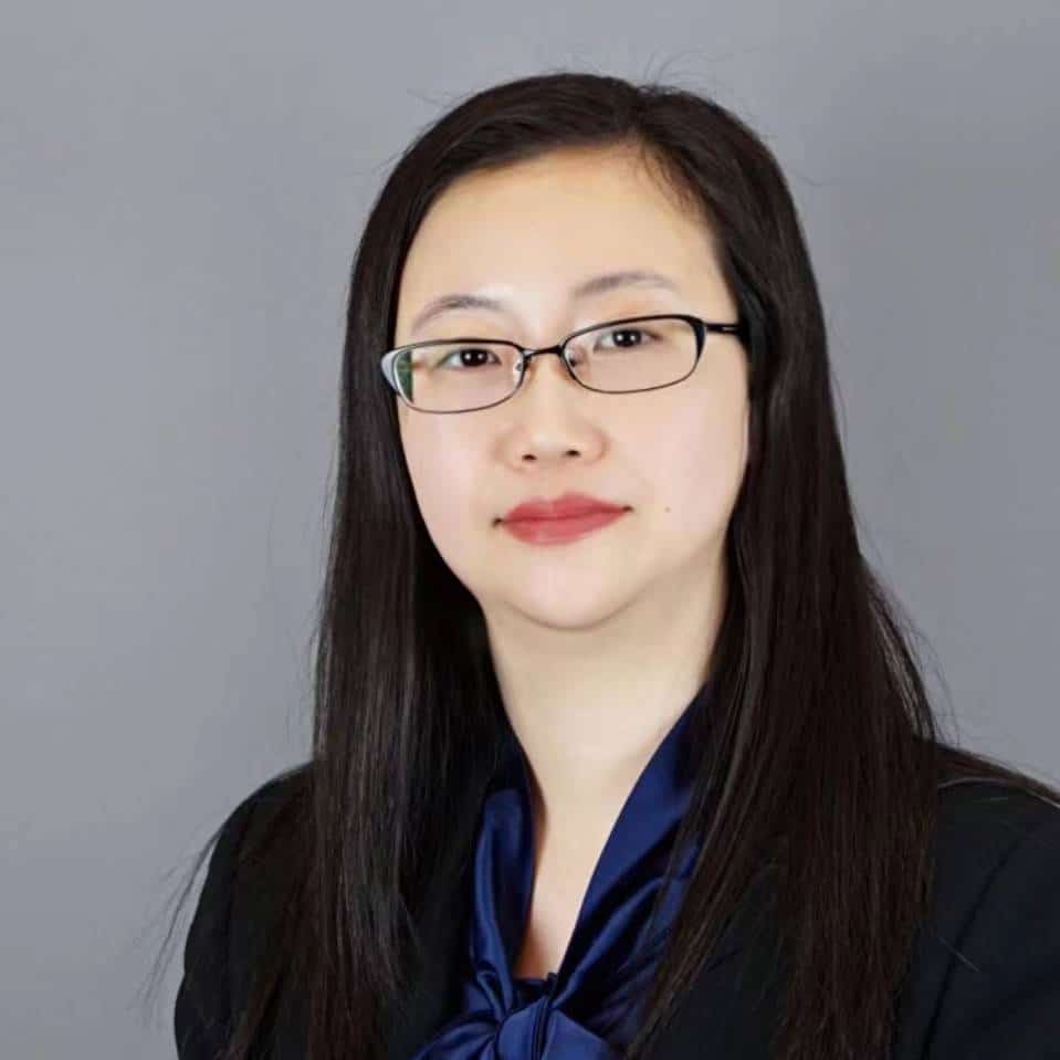 A portrait of Moon Zhang, UKEC's CEO. She wears glasses and has shoulder length black hair